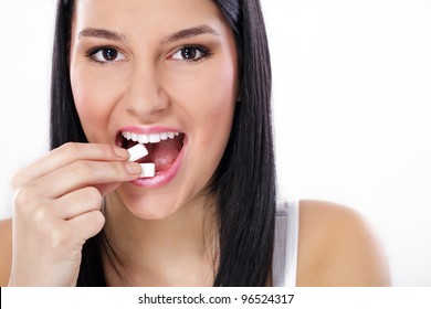 Young Charming Smiling Woman Puts In Mouth Chewing Gum, Close Up