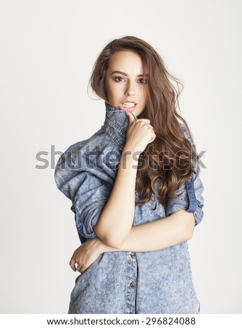 young cheerful brunette teenage girl on white background smiling