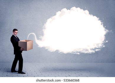 A young cheerful business person holding a cardboard box with illustration of white empty cloud concept.