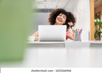 Young cheerful business woman as a trainee in training on laptop computer