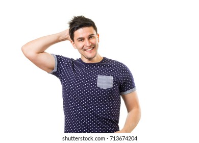 Young Cheerful Carefree Brunet Guy Scratching His Back Of The Head Isolated On White