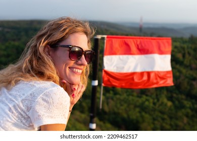 Young cheerful Caucasian woman relaxing in nature at Austrian flag, Austria