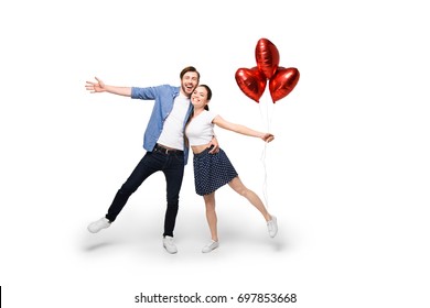 Young Cheerful Couple With Heart Shaped Balloons, Isolated On White 