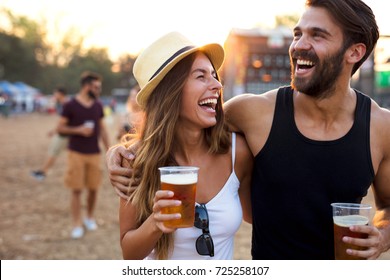 Young and cheerful couple in music festival. - Powered by Shutterstock