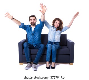 Young Cheerful Couple Sitting On Sofa And Watching Football Isolated On White Background