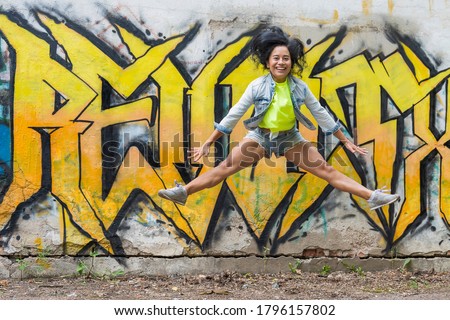 Similar – Happy women jumping in front of garden fence