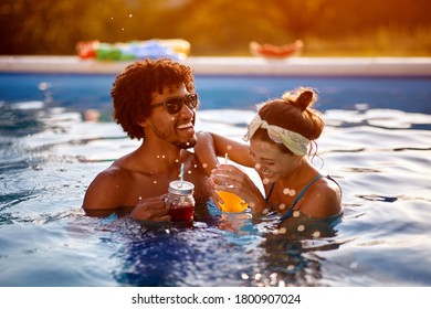 Young cheerful girl and men having fun at summer in pool. - Powered by Shutterstock