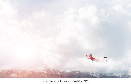 Young Cheerful Man Flying High In Sky And Playing Fife