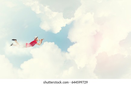 Young Cheerful Man Flying High In Sky And Playing Fife