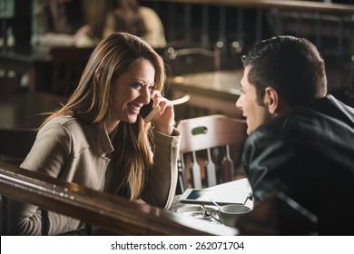 Young Cheerful Man And Woman Dating And Spending Time Together At The Bar