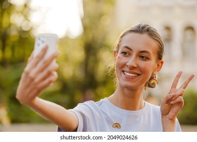 Young Cheerful Woman Standing And Making Selfie During Pride Parade On A Street Street