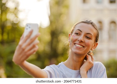 Young Cheerful Woman Standing And Making Selfie During Pride Parade On A Street Street