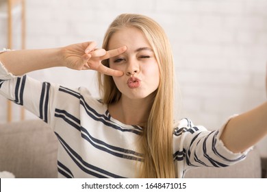 Young Cheerful Woman Taking Funny Selfie, Showing Peace Gesture And Duck Face