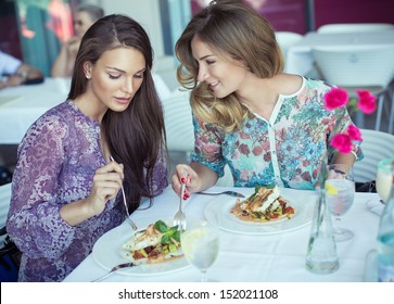 Young Cheerful Women On Lunch At Restaurant 