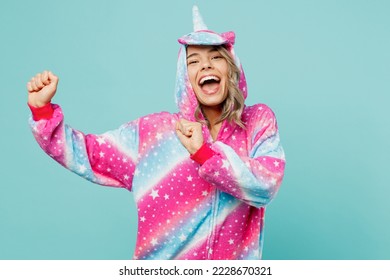 Young cheerful ywoman 20s she wear domestic costume with hoody and animals ears gesticulating hands dance on pajama party isolated on plain pastel light blue cyan background. People lifestyle concept