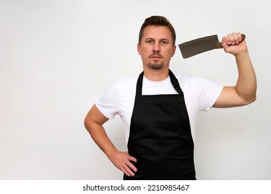 Young Chef With Cutting Knife. Butcher In A Black Apron Holding Kitchen Cleaver