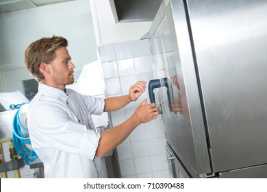 Young Chef Opening Restaurant Kitchen Fridge