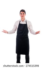 Young chef or waiter posing, wearing black apron and white shirt isolated on white background