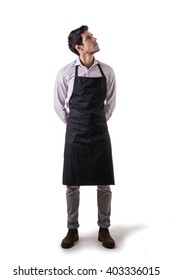 Young Chef Or Waiter Wearing Black Apron Isolated