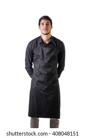 Young Chef Or Waiter Wearing Black Apron Isolated