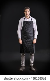 Young Chef Or Waiter Wearing Black Apron 