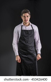 Young Chef Or Waiter Wearing Black Apron 