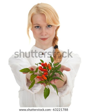 young chef woman with bunch of chilli, pepperoni