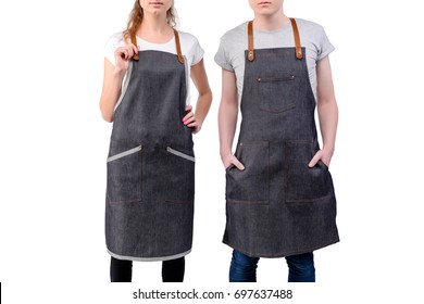 Young chefs or waiters man and woman posing, wearing aprons isolated on white background. Barista cafe coffee uniform. - Powered by Shutterstock