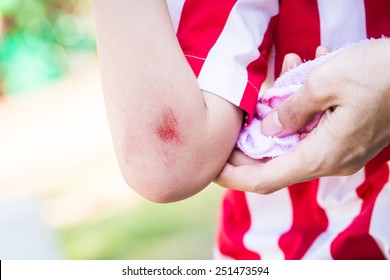 Young Child With Bleeding Arm Wound Near Elbow