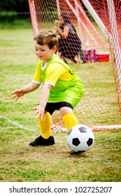 Young Child Boy Playing Soccer Goalie During Organized League Game