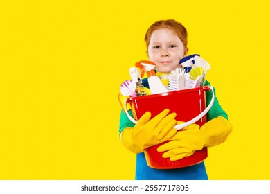 Young child with cleaning supplies in a bright yellow background holds a red bucket amidst household chores - Powered by Shutterstock