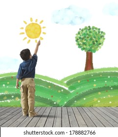 Young child draws green panorama in wall