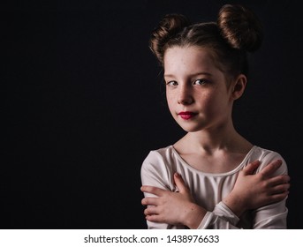 Young child dressed up as sci fi space movie princess with 2 buns on her head.