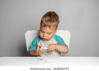 Young child exploring creativity with marker