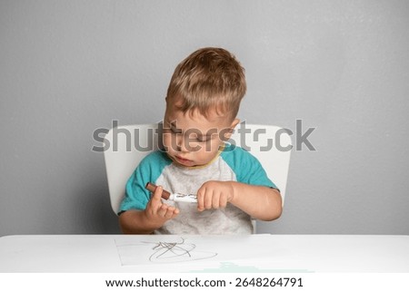 Young child exploring creativity with marker