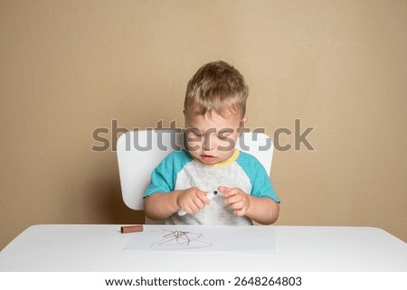 Young child exploring creativity with marker