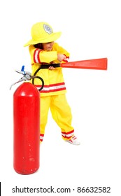 Young Child As Firefighter Holding A Fire Extinguisher