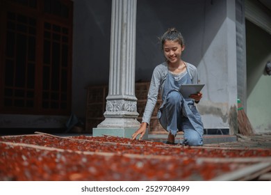 A young child gathers fresh fruit under the sun, showcasing agricultural tradition. - Powered by Shutterstock