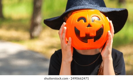 Young child girl poses in a scary witch Halloween costume. - Powered by Shutterstock