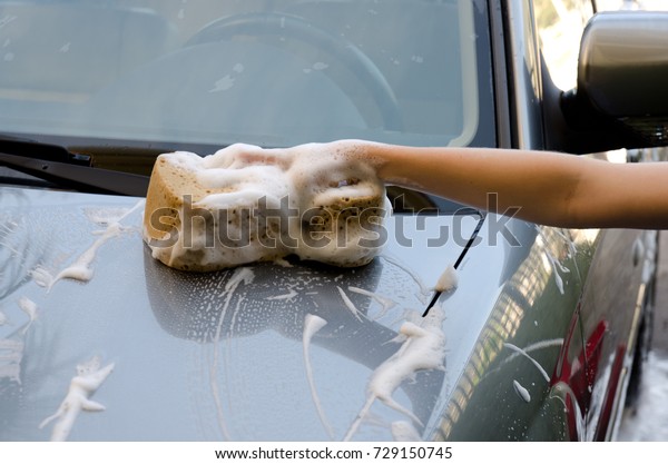 Young child helping
out by washing the car