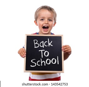 Young Child Holding Back To School Chalk Blackboard Sign Standing Against White Background