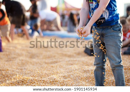young child holding corn seeds