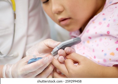 Young Child In Hospital Getting A Blood Test With Doctor