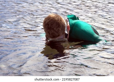 Young Child Investigates Rock Pools With Diving Mask