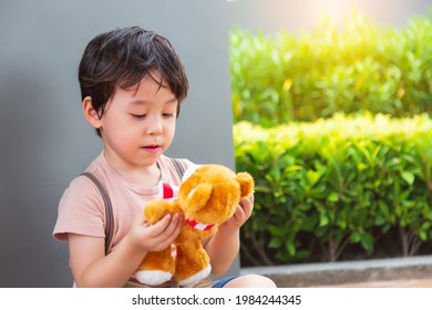 Young child playing his favorite toy or imaginary friend Little boy talking with teddy bear Happy children stay alone with toy He get lonely Preschool son is only child of family He always play alone