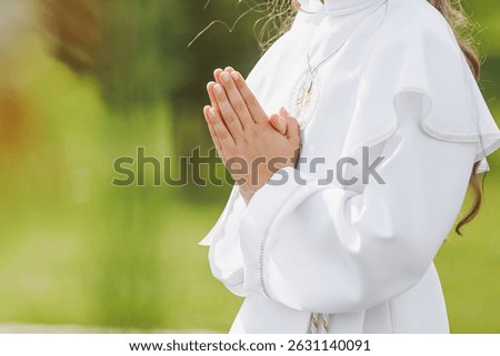 A young child prays while receiving a sacrament during a Catholic church service. A moment of personal faith, silence, and sacred connection in religious tradition.