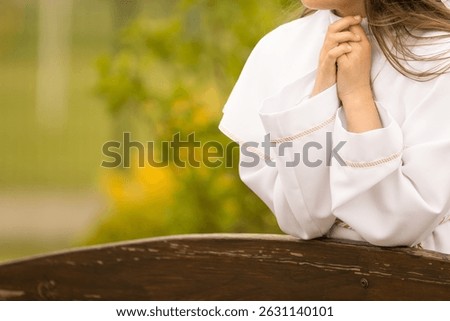 A young child prays while receiving a sacrament during a Catholic church service. A moment of personal faith, silence, and sacred connection in religious tradition.