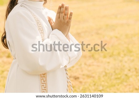 A young child prays while receiving a sacrament during a Catholic church service. A moment of personal faith, silence, and sacred connection in religious tradition.