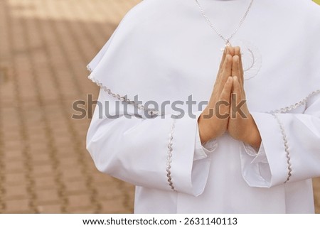 A young child prays while receiving a sacrament during a Catholic church service. A moment of personal faith, silence, and sacred connection in religious tradition.