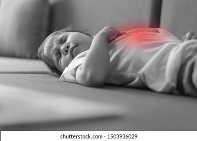 Young Child Suffering From A Painful Stomach Ache. 